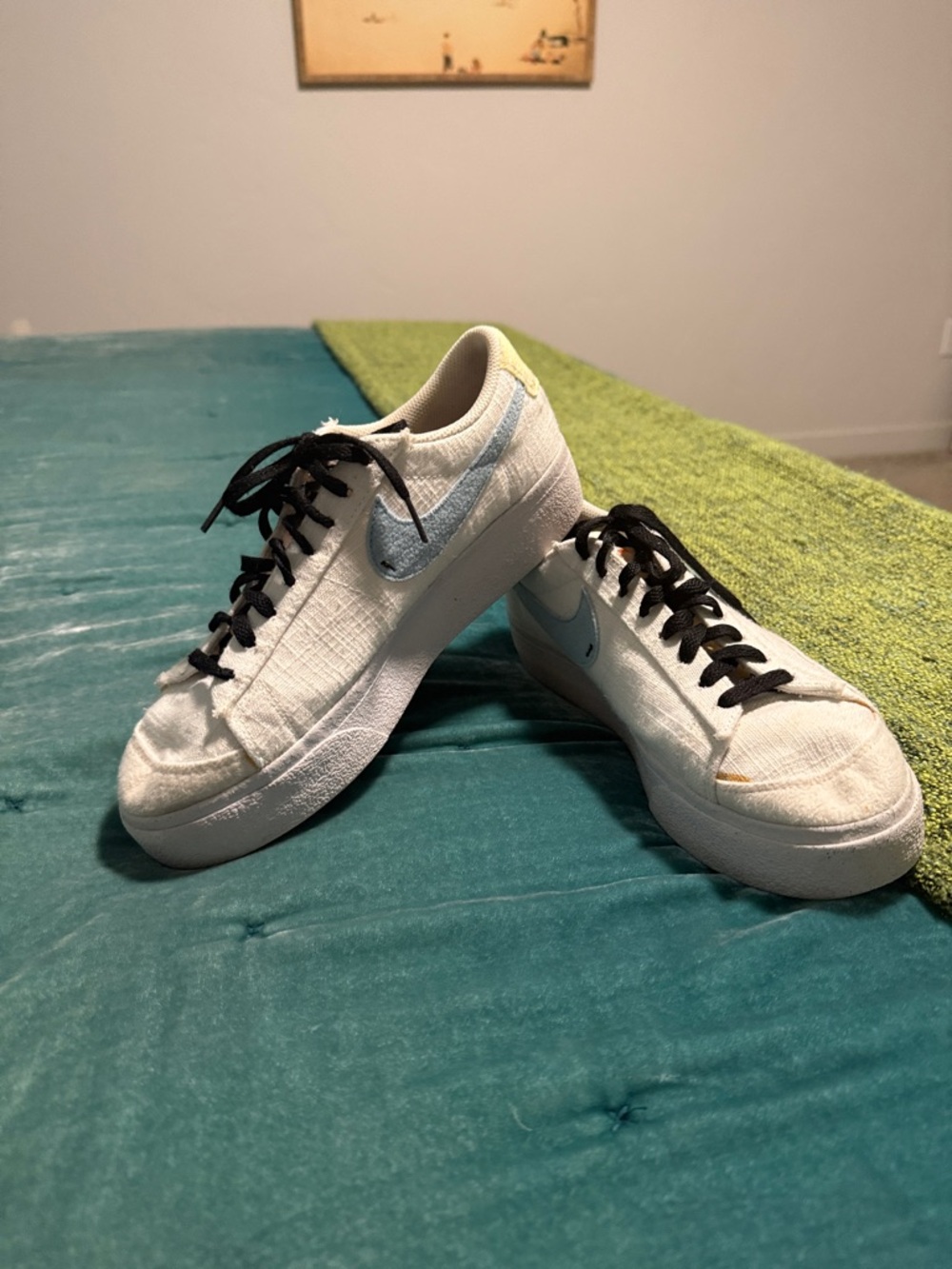 Nike White Low-Top Sneakers with Light Blue Swoosh and Black Laces
